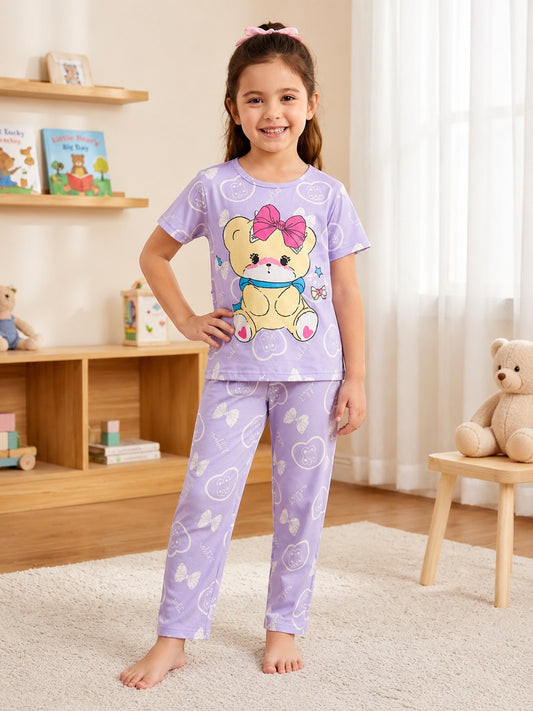 Chillpjs lavender cotton night suit with teddy bear print worn by a smiling girl in a cozy bedroom setting.