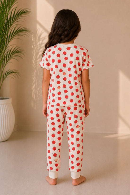 Chillpjs Apple Bliss night suit featuring a red apple print on cream cotton, worn by a girl, back view.