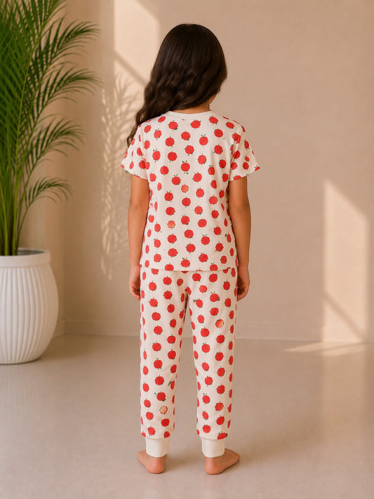 Chillpjs Apple Bliss night suit featuring a red apple print on cream cotton, worn by a girl, back view.