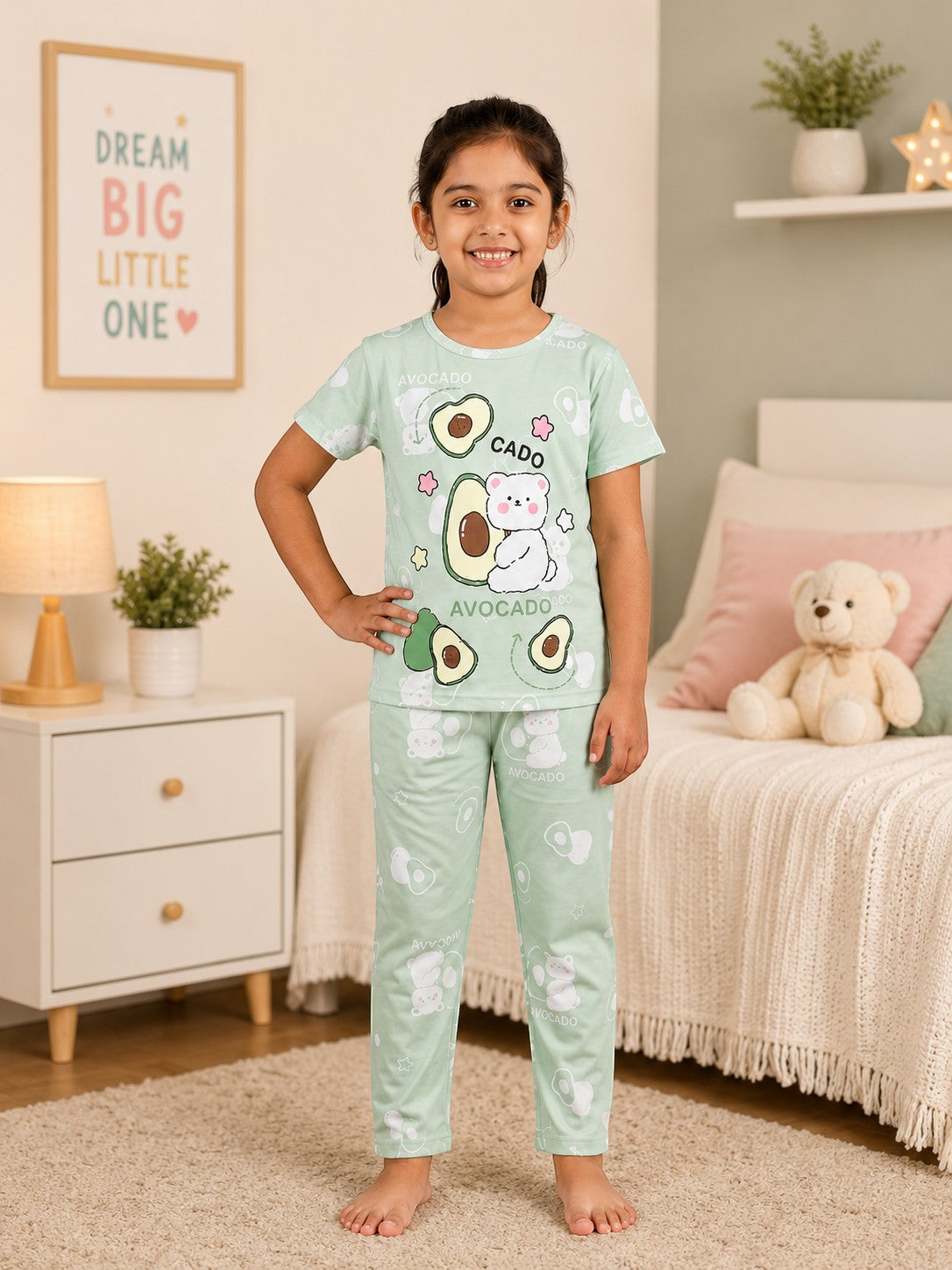 Chillpjs pastel green cotton night suit featuring a cute avocado and bear print worn by a young girl in a bedroom.