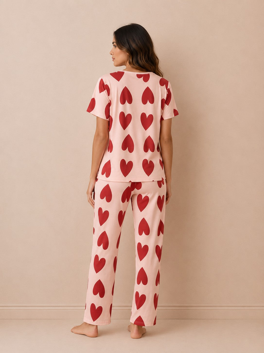 Chillpjs blush pink cotton pajama set with red heart print, featuring a short-sleeve top and pants, back view.