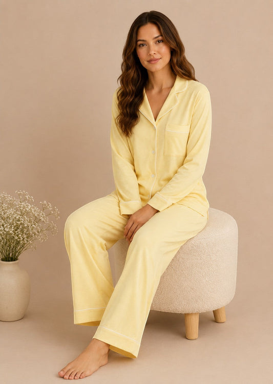 Woman wearing a Chillpjs butter yellow soft linen pajama set with long sleeves and a notch lapel collar.