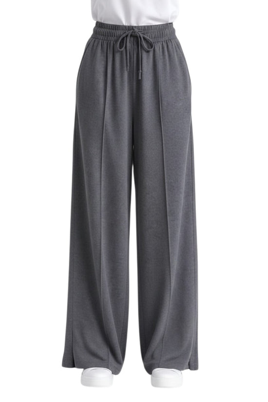 Chillpjs high-waisted wide-leg lounge pants in charcoal grey with a drawstring waist, center seams, and side slits.