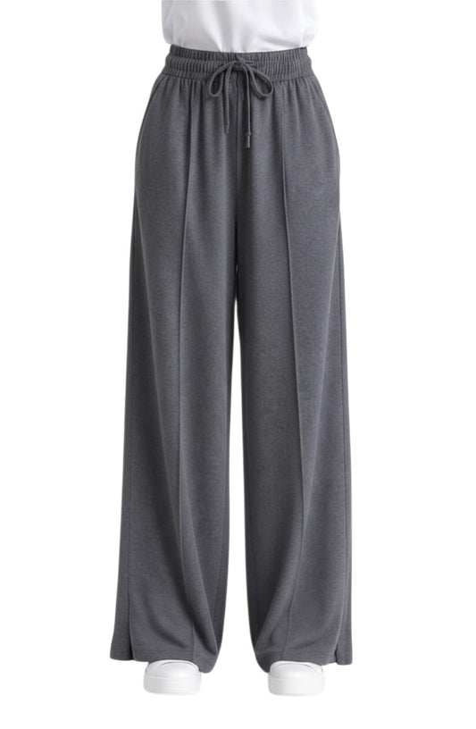 Chillpjs high-waisted wide-leg lounge pants in charcoal grey with a drawstring waist, center seams, and side slits.