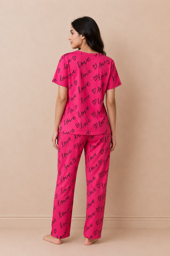 Chillpjs Crimson Love Sleepwear set featuring a vibrant pink short-sleeve top and matching trousers with black heart and love print