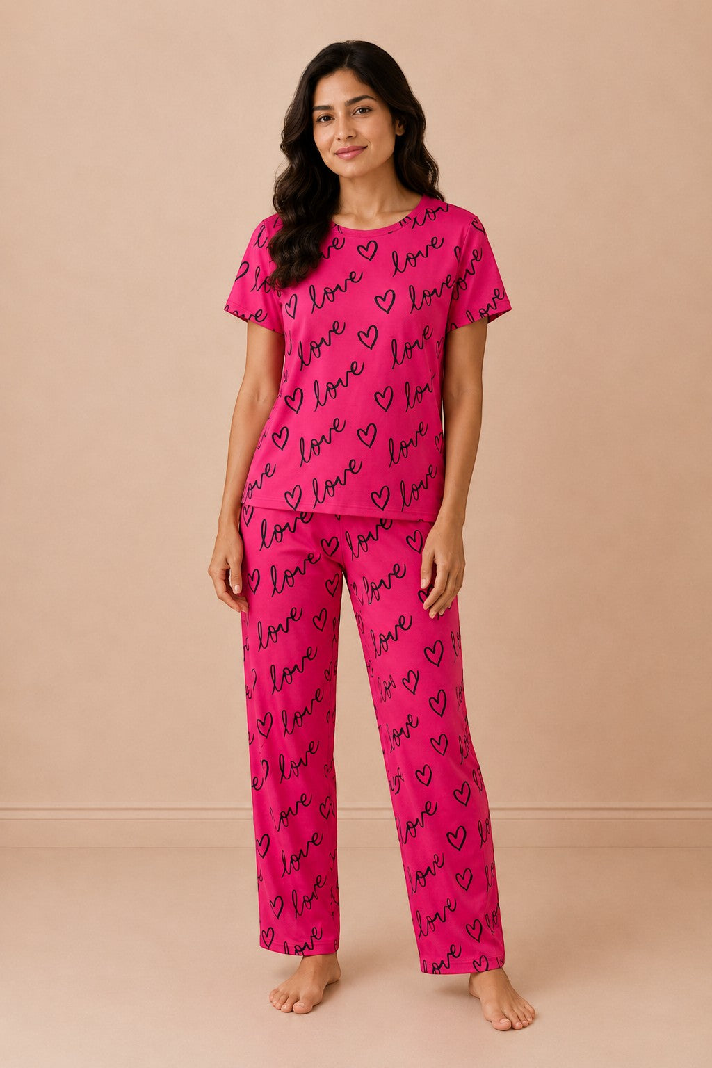 Chillpjs crimson sleepwear set featuring a short-sleeve top and pants with black love and heart print on a woman