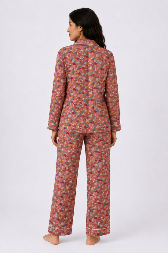 Back view of a woman wearing the Chillpjs Flora Muse linen night set with a vibrant multicolor floral print.