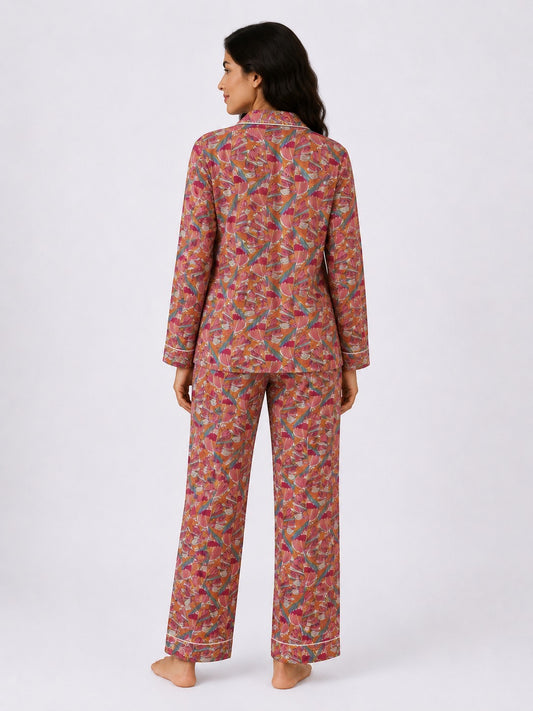 Back view of a woman wearing the Chillpjs Flora Muse linen night set with a vibrant multicolor floral print.