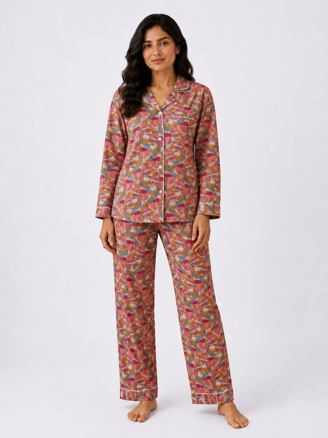 Woman wearing a Chillpjs Flora Muse linen night set with a vibrant multicolor floral print and contrast piping.