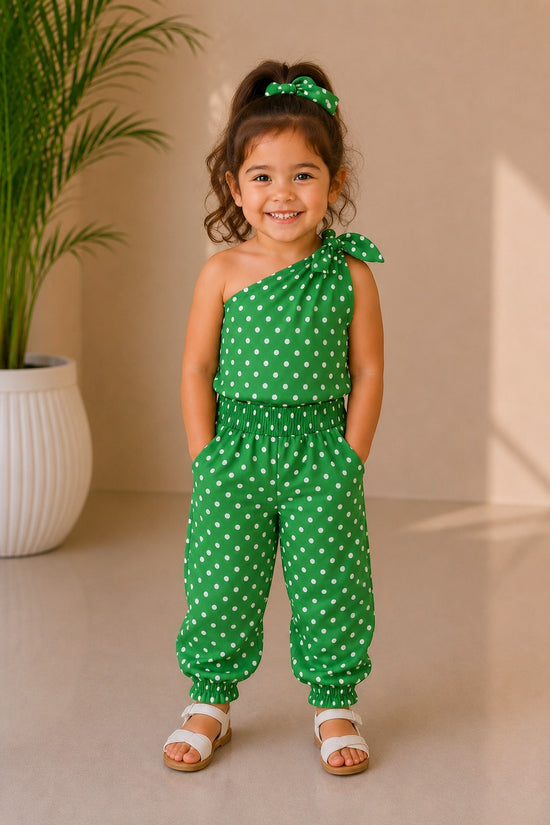 Chillpjs green polka dot kids night suit with tie-shoulder detail, elasticated waist, and jogger cuffs on a young girl