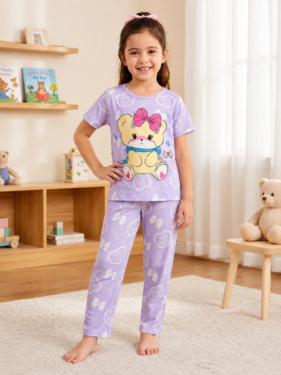 Chillpjs lavender cotton night suit with teddy bear print worn by a smiling girl in a cozy bedroom setting.