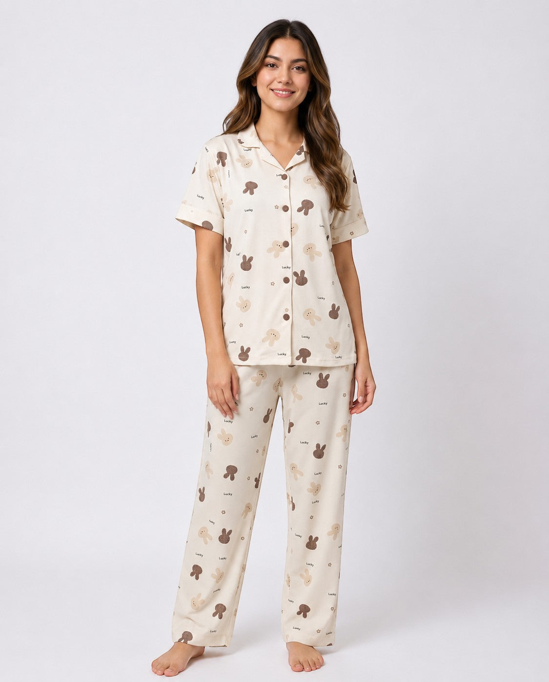Model wearing Chillpjs Lucky Bunny short-sleeve pajama set in sandstone cream popcorn crinkle fabric with bunny print.