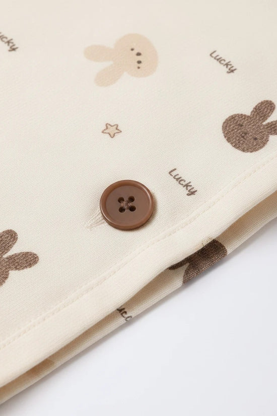 Chillpjs Lucky Bunny pajama set in sandstone cream popcorn crinkle fabric with brown button and mocha bunny print