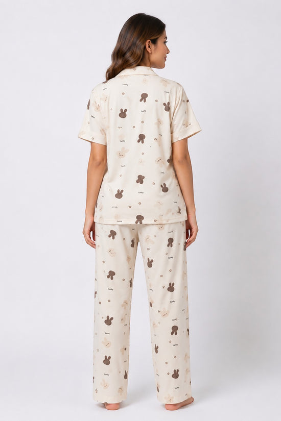Chillpjs Lucky Bunny pajama set in sandstone cream with brown bunny print, featuring popcorn crinkle fabric, back view.