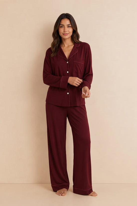 Model wearing a maroon Chillpjs soft linen pajama set with a long-sleeve button-up shirt and wide-leg trousers.
