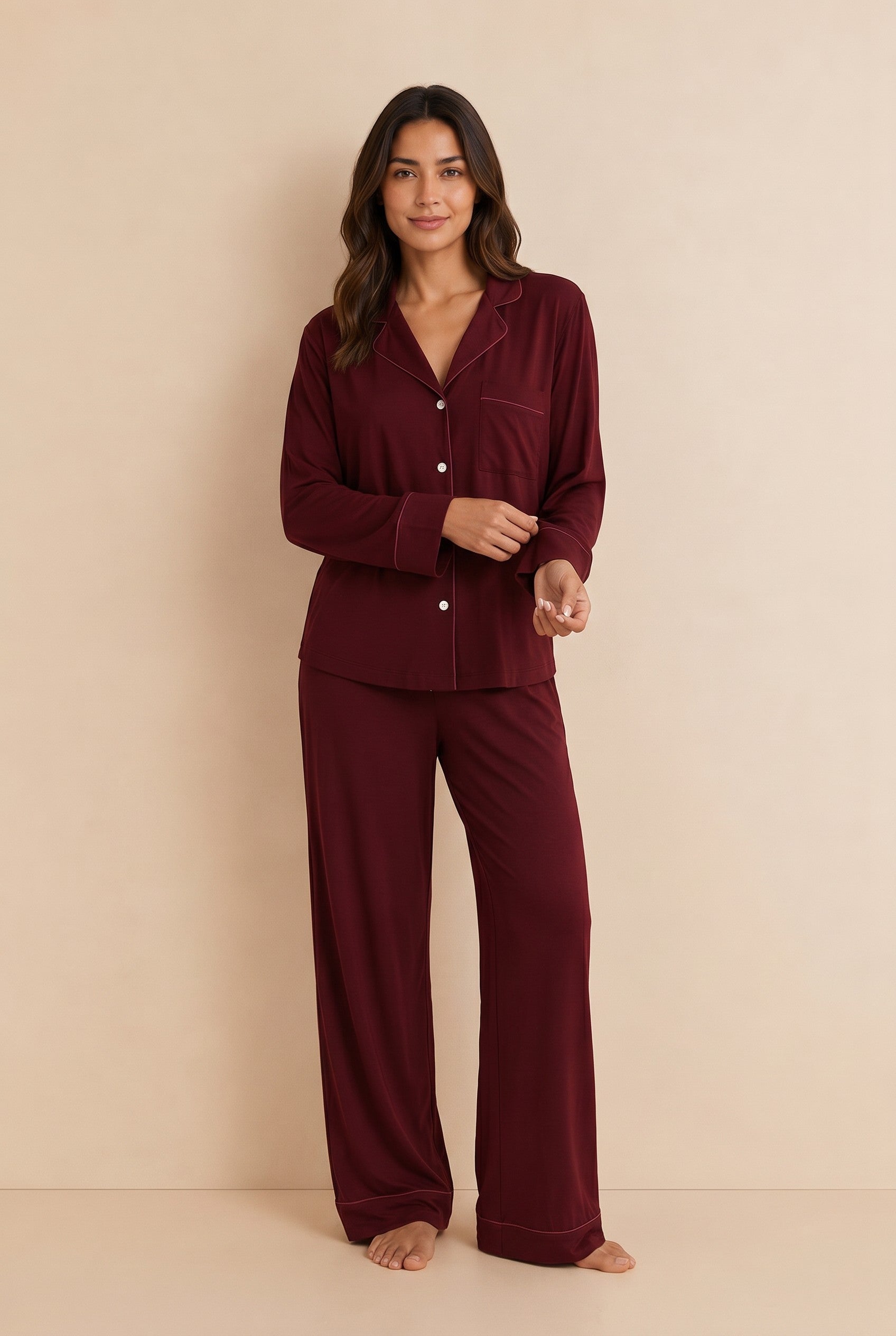 Model wearing a maroon Chillpjs soft linen pajama set with a long-sleeve button-up shirt and wide-leg trousers.