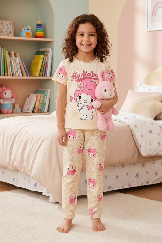 Chillpjs My Melody cotton night suit on a smiling girl holding a pink plush toy in a cozy bedroom setting.