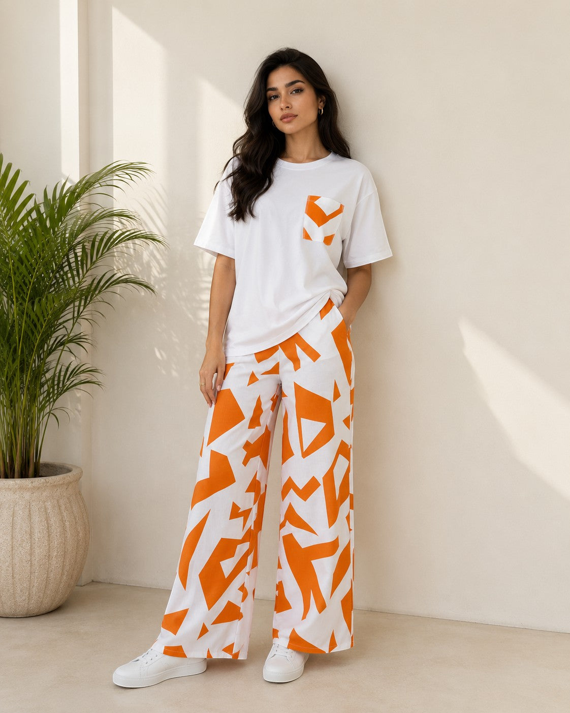 Chillpjs Urban Pop lounge set featuring a white relaxed t-shirt and wide-leg trousers with a bold orange abstract print