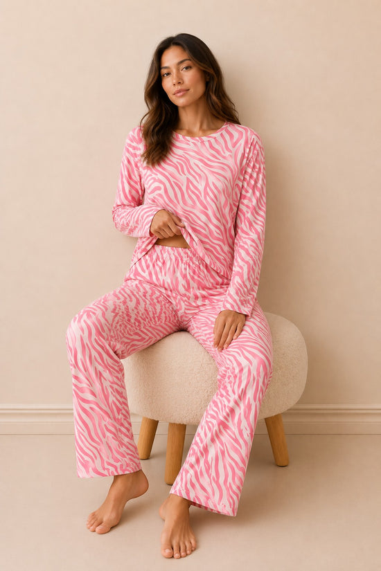 Model wearing Chillpjs pink zebra print long-sleeve lounge set with matching straight-fit trousers