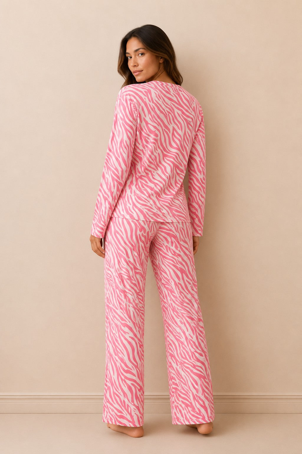 Model wearing Chillpjs pink zebra print long-sleeve lounge set with straight-fit trousers, back view.