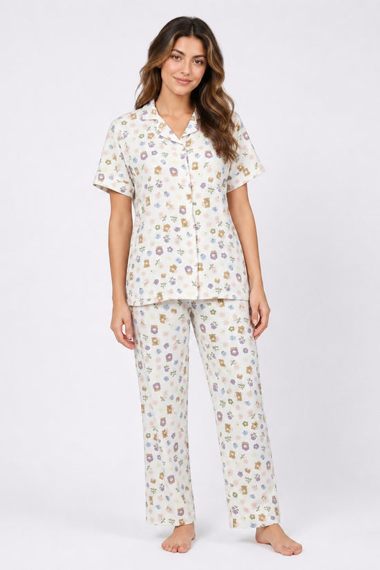 Model wearing Chillpjs wildflower popcorn crinkle pajama set with short sleeves and floral print on cream fabric.